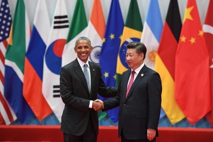 China's President Xi Jinping (R) shakes hands with US President Barack Obama before the G20 leaders' family photo in Hangzhou on September 4, 2016