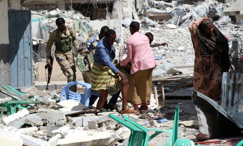 A victim is removed from the Maka Al-Mukarama hotel in Mogadishu on March 1, 2019 following a 24-hour seige by Al-Shabaab jihadists