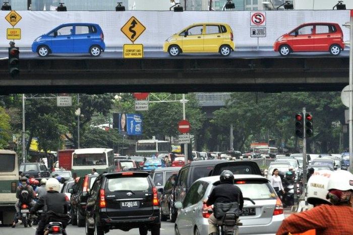The X-rated clip was seen by motorists as they crawled along the major road in Jakarta