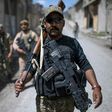 A member of Iraq's elite Rapid Response Division walks down a street during their advance in western Mosul on April 19, 2017