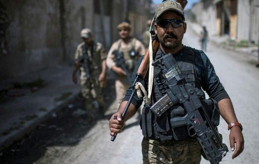 A member of Iraq's elite Rapid Response Division walks down a street during their advance in western Mosul on April 19, 2017