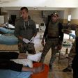 Members of the Iraqi forces tend to a civilian who was injured by Islamic State (IS) group jihadists at a school turned hospital in western Mosul on March 24, 2017