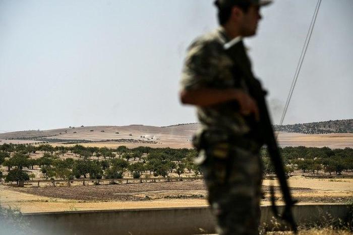 A Turkish soldier stands guard in the Turkish Syrian border city of Karkamis