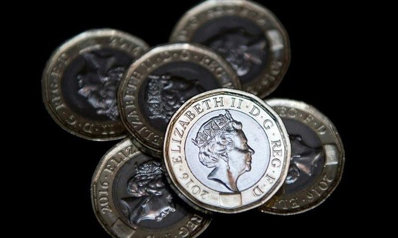 Newly issued 12-sided £1 (one pound) coins pictured in London on March 28, 2017, the day they entered UK circulation