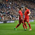 Liverpool's Roberto Firmino (L) celebrates scoring the opening goal with teammate Emre Can during their English Premier League football match against West Bromwich Albion on April 16, 2017