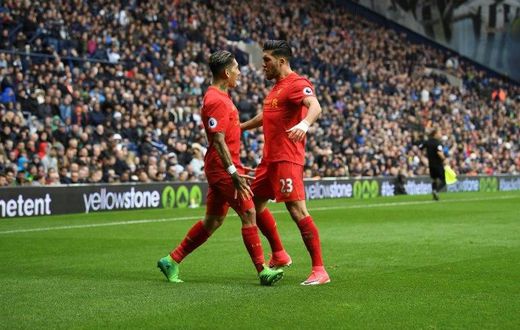 Liverpool's Roberto Firmino (L) celebrates scoring the opening goal with teammate Emre Can during their English Premier League football match against West Bromwich Albion on April 16, 2017