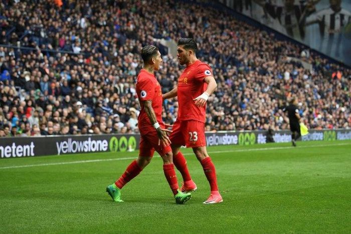 Liverpool's Roberto Firmino (L) celebrates scoring the opening goal with teammate Emre Can during their English Premier League football match against West Bromwich Albion on April 16, 2017