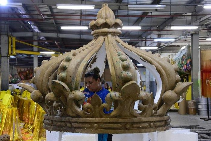 A woman works on the floats of the Sao Clemente samba school in Rio de Janeiro which this year features a lavish portrayal of France under the Sun King, Louis XIV