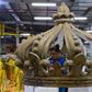 A woman works on the floats of the Sao Clemente samba school in Rio de Janeiro which this year features a lavish portrayal of France under the Sun King, Louis XIV