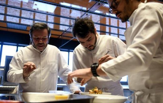 Michel Troisgros (L) cooks with his sons Cesar (R) and Leo in the new Troisgros restaurant, a veritable shrine to France's haute cuisine
