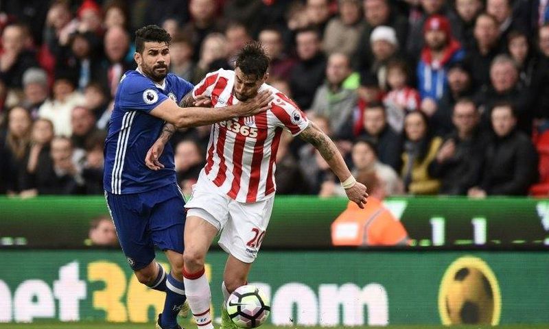Chelsea's Diego Costa (L) fights for the ball with Stoke City's Geoff Cameron during their English Premier League match, at the Bet365 Stadium in Stoke-on-Trent, on March 18, 2017