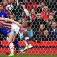 West Ham United's Andre Ayew (R) tries an overhead shot, which is saved by Stoke City's Jack Butland during their match in Stoke-on-Trent, central England on April 29, 2017