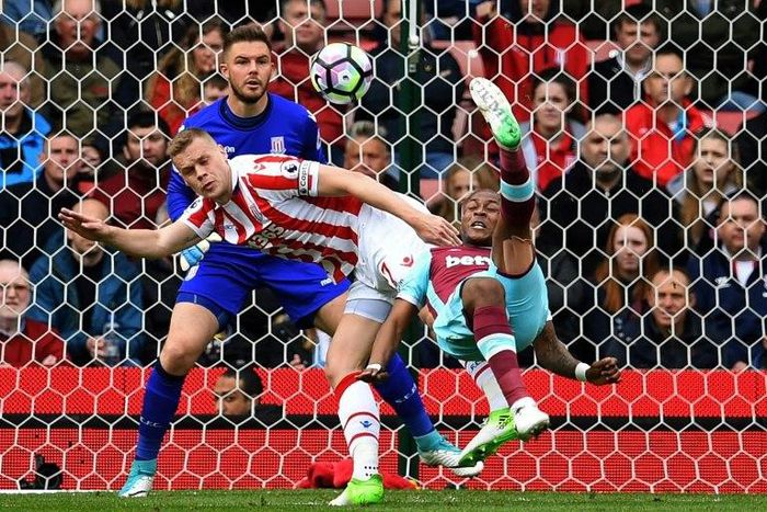West Ham United's Andre Ayew (R) tries an overhead shot, which is saved by Stoke City's Jack Butland during their match in Stoke-on-Trent, central England on April 29, 2017