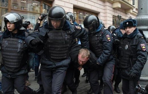Russian police officers detain a man in central Moscow on April 2, 2017, as Russian opposition promised protests after police detained hundreds of people during anti-corruption rallies