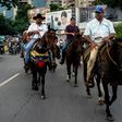 In the Venezuelan capital Caracas protesters on motorcycles, bikes and even horseback tried to clog a key highway clashing with riot police firing tear gas