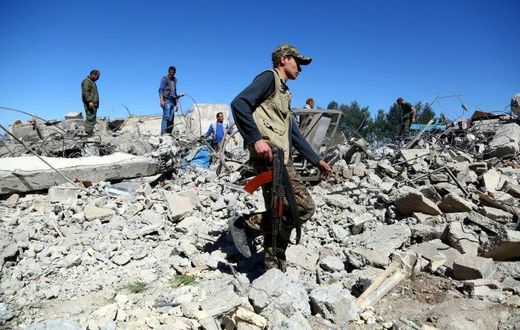 Fighters from the Kurdish People's Protection Units (YPG) visit the site of Turkish airstrikes near northeastern Syrian Kurdish town of Al-Malikiyah on April 25, 2017