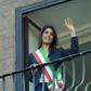 Newly elected mayor of Rome, Virginia Raggi, waves to people from the balcony of Rome's city hall on June 23, 2016, after her official investiture