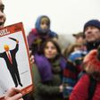 A young woman holds the last edition of "Der Spiegel" magazine with a cover designed by Edel Rodriguez, as she protests against the travel ban imposed by US President Donald Trump, on February 4, 2017, in Berlin