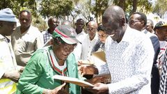 Deputy President William Ruto issues a title deed to one of the locals at Chala Njukini, Taita Taveta County.