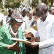 Deputy President William Ruto issues a title deed to one of the locals at Chala Njukini, Taita Taveta County.