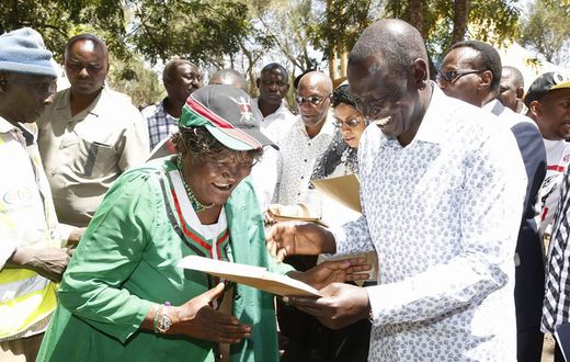 Deputy President William Ruto issues a title deed to one of the locals at Chala Njukini, Taita Taveta County.