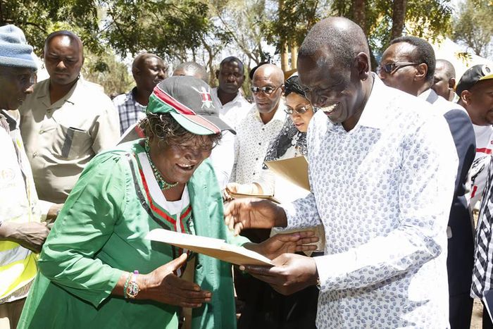 Deputy President William Ruto issues a title deed to one of the locals at Chala Njukini, Taita Taveta County.