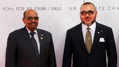 Sudanese President Omar al-Bashir (L) and Morocco's King Mohammed VI pose for a photograph as they arrive for the COP22 Climate Change Conference in Marrakesh on November 15, 2016