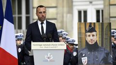 Etienne Cardiles -- stands beside a portrait of his slain partner Xavier Jugele -- during a ceremony to honour the policeman who was killed by a jihadist gunman in April 2017