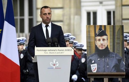 Etienne Cardiles -- stands beside a portrait of his slain partner Xavier Jugele -- during a ceremony to honour the policeman who was killed by a jihadist gunman in April 2017