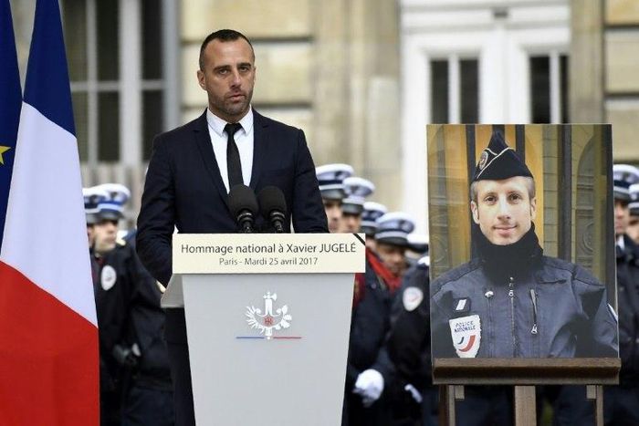Etienne Cardiles -- stands beside a portrait of his slain partner Xavier Jugele -- during a ceremony to honour the policeman who was killed by a jihadist gunman in April 2017