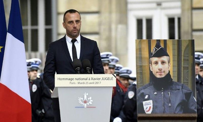 Etienne Cardiles -- stands beside a portrait of his slain partner Xavier Jugele -- during a ceremony to honour the policeman who was killed by a jihadist gunman in April 2017