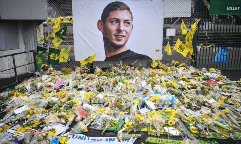 Yellow flowers are displayed in front of a portrait of Argentinian forward Emiliano Sala at the Beaujoire stadium in Nantes, France -- Sala was traveling from Nantes to his new club Cardiff City when he died
