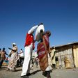 South Sudanese refugees collect aid food at a "Refugee Waiting Centre" in Al-Eligat area along the border in Sudan's White Nile state on February 27, 2017