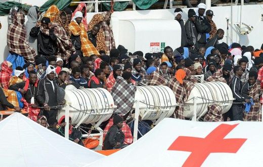 Would be immigrants wait to disembark in the port of Catania, on the island of Sicily on March 21, 2017 from the ship "Aquarius" following a rescue operation in the Mediterranean sea, where some 946 would be immigrants have been rescued