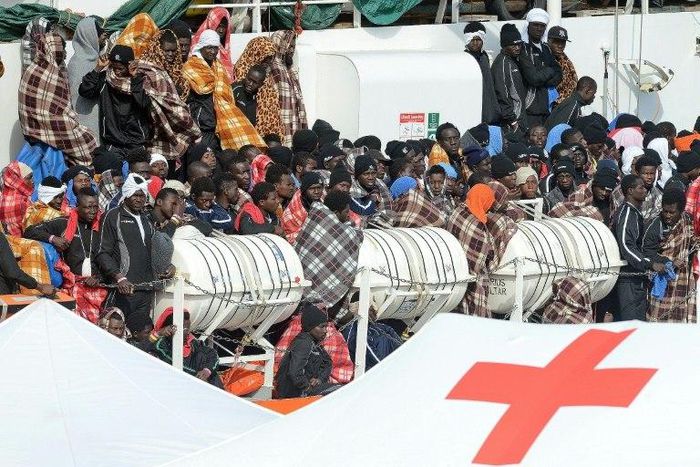 Would be immigrants wait to disembark in the port of Catania, on the island of Sicily on March 21, 2017 from the ship "Aquarius" following a rescue operation in the Mediterranean sea, where some 946 would be immigrants have been rescued