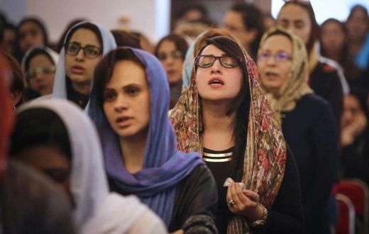 Egyptians pray during the Good Friday procession at the St. George church in Mahalla in northern Egypt on April 14, 2017