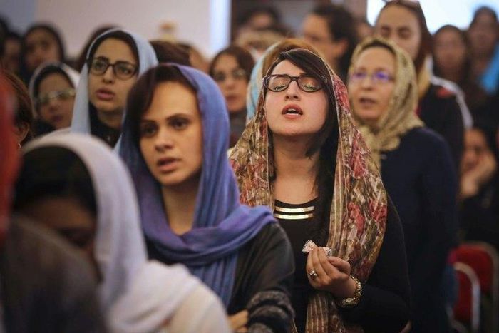 Egyptians pray during the Good Friday procession at the St. George church in Mahalla in northern Egypt on April 14, 2017