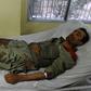 An injured policeman lies on a bed at a hospital in Quetta on October 25, 2016 after a militant attack targeting a Pakistani police academy