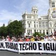 People hold a banner that reads "Bread, work, roof and equality" during a demonstration in Madrid on May 27, 2017 to denounce degraded working conditions