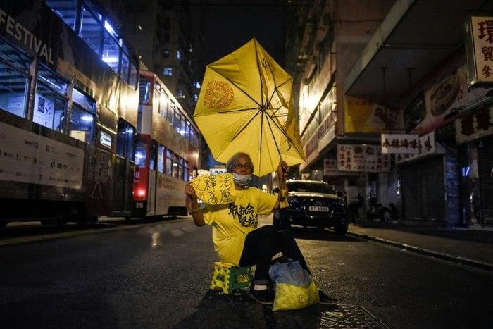 A protester holds a yellow umbrella as she protests in Hong Kong, early on November 7, 2016