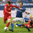 Schalke's defender Benedikt Hoewedes and Leipzig's midfielder Oliver Burke fight for the ball on April 23, 2017