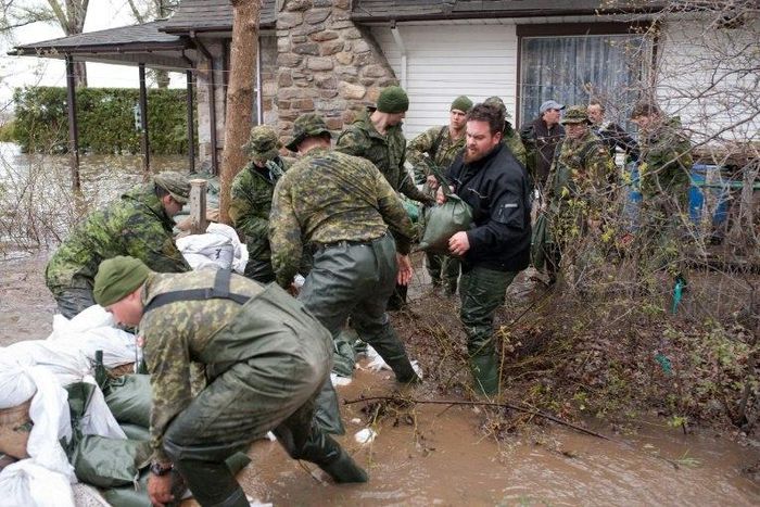 Soldiers help residents of Pierrefonds after heavy flooding caused by unrelenting rain