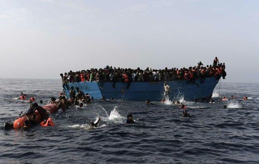 Migrants wait to be rescued by members of Proactiva Open Arms NGO in the Mediterranean Sea, some 12 nautical miles north of Libya, on October 4, 2016