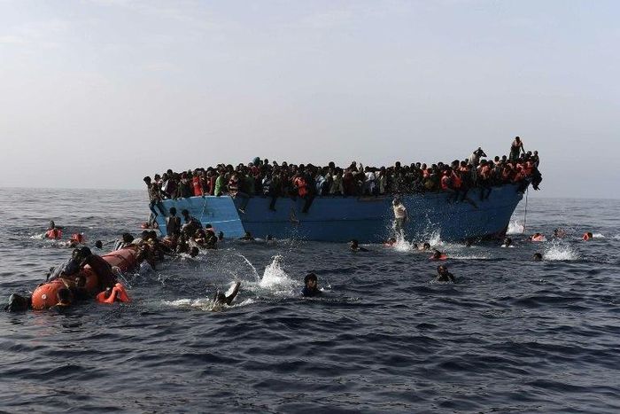 Migrants wait to be rescued by members of Proactiva Open Arms NGO in the Mediterranean Sea, some 12 nautical miles north of Libya, on October 4, 2016