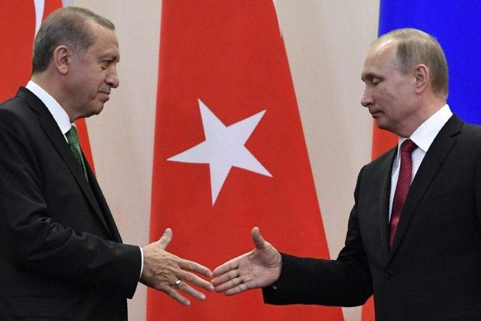 Russian President Vladimir Putin (R) shakes hands with his Turkish counterpart Recep Tayyip Erdogan after a joint press conference following their meeting at the Bocharov Ruchei state residence in Sochi on May 3, 2017