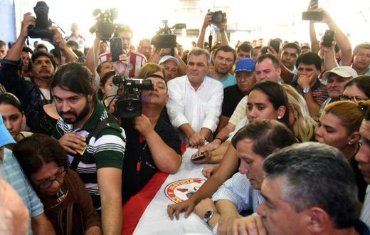 Relatives and friends mourn over the coffin of Rodrigo Quintana, leader of the opposition Liberal Party's youth branch, who was shot dead by police in Asuncion on March 31, 2017