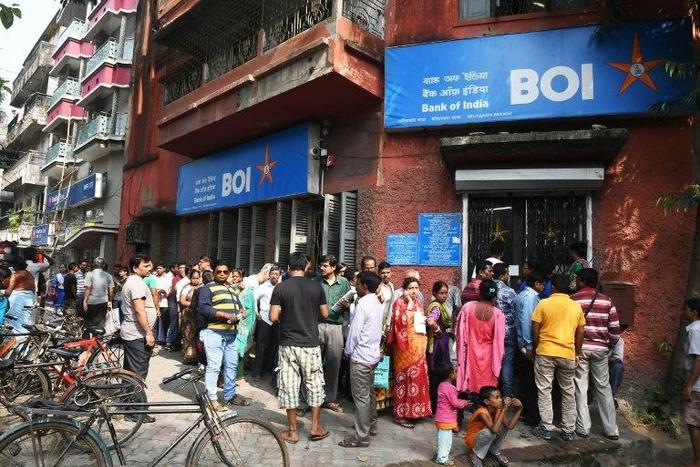 People queue outside a bank in Kolkata to deposit and exchange 500 and 1000 currency notes after the government's shock decision to withdraw them from circulation