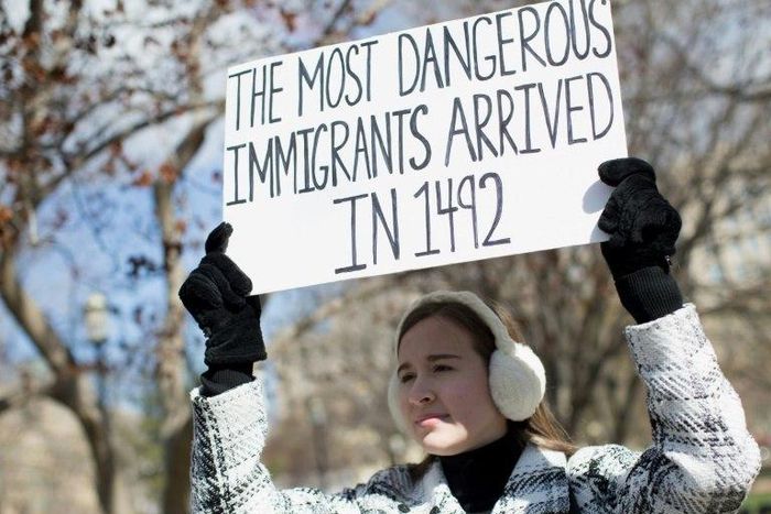 A demonstrator holds a sign near the White House to protest President Donald Trump's travel ban on six Muslim countries