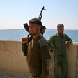Fighters of the US-backed Syrian Democratic Forces guard a section of Tabqa Dam under their control on March 28, 2017