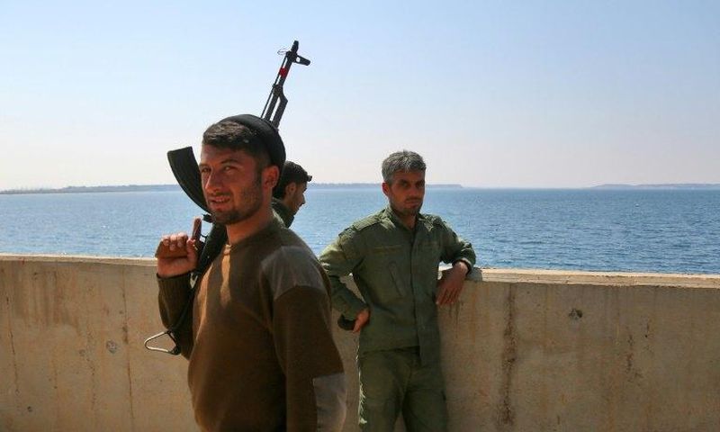 Fighters of the US-backed Syrian Democratic Forces guard a section of Tabqa Dam under their control on March 28, 2017